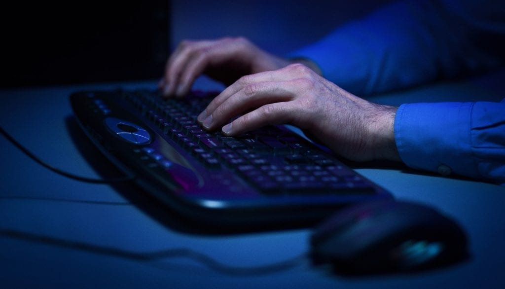 Hacker hacking the server in the dark room
